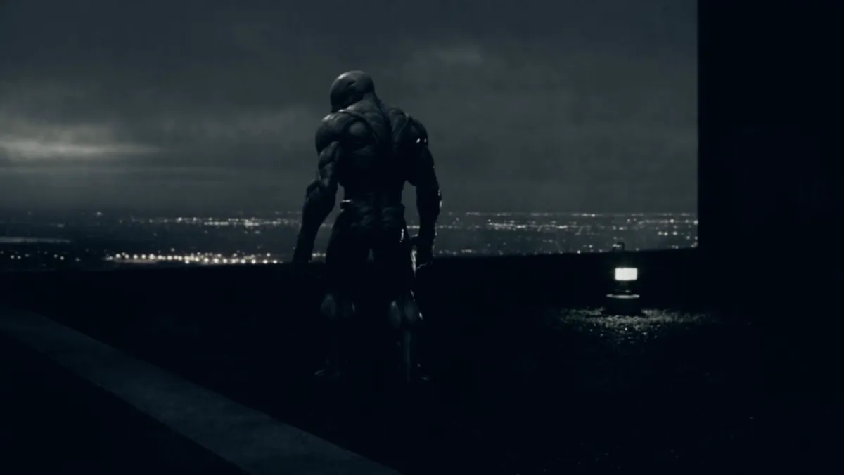 A fully transformed figure standing on a rooftop edge above the city lights