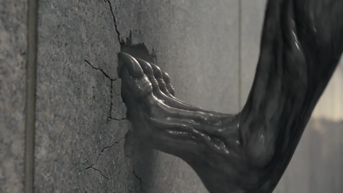A clawed arm against cracked stone